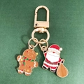 Christmas keychain with gingerbread man and Santa Claus enamel charms in gold finish - Gingerbread Man and Santa Claus