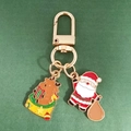 Christmas enamel keychain featuring cute reindeer and Santa Claus charms with gold clasp - Reindeer And Santa