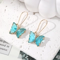 Elegant gold butterfly hook earrings featuring light blue crystal wings and zircons - Light Blue