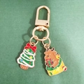 Christmas reindeer and tree keychain with golden metal clasp on green texture background - Bow Christmas Tree and Reindeer