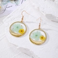 Detailed view of handmade stainless steel earrings with real blue and yellow dried flowers - Blue Yellow Flowers