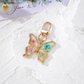 Luminous gold butterfly keychain with real dried flowers and resin daisy pendant - Pink Blue Butterfly