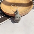 Detailed macro view of the grey flocked rabbit pendant texture with a white lanyard strap - Angry Gray Bunny