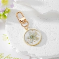 Handmade clear resin keychain with blue dried flower, gold foil, and gold hardware - Five-petal Blue Flower