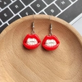 Quirky vampire red lip earrings with fangs on a wooden tray with a creative gothic style - Vampire Red Lips