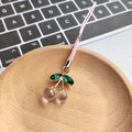 Pink resin cherry keychain with faceted crystal beads and green leaves on wooden plate - Pink Cherry