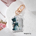 Detail view of acrylic kitten keychain with gold lobster clasp and size dimensions - Stacked Cats