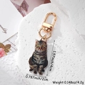 Macro shot of a realistic tabby cat acrylic keychain with a golden D-ring metal clasp - Leopard Print Cat