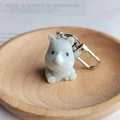 Cute light gray flocked rhinoceros keychain with silver metal carabiner in a wooden tray - Sitting Cute Rhino