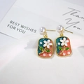 Detail of French vintage gold earrings with enamel floral pendant and pearl studs - Blue Orange Color Block White Flower Style