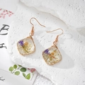 Detail of square resin earrings with purple dried flowers on a white stone background - Transparent Purple Flower (Stainless Steel Hook)
