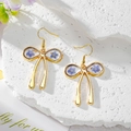 Elegant gold bow earrings with blue dried flowers and gold foil in resin, long drop style - Little Blue Flower