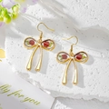Golden bow earrings with red roses in transparent resin on white stone base - Red Rose Green Leaf