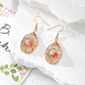 Detail of handmade resin drop earrings with pink dried flowers and gold wire wrap - Pink Floral