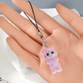 Detailed view of pink flocked kitten keychain with metal lobster clasp on a hand model - Pink Gradient Cat