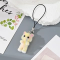 Detail of a fluffy yellow resin cat pendant with pink stripes and silver metal clasp - Yellow Gradient Cat
