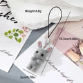 Detail of grey flocked rabbit keychain with size and weight specs on a floral background - Grey Rabbit