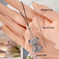 Close-up of a grey flocked resin bear keychain with a silver lobster clasp and black lanyard - MR07 Brown Bear