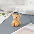 Detailed close-up of orange flocked resin bear pendant with soft texture and white rope loop - MR07 Yellow Bear