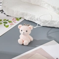 Close-up of a pink flocked resin bear pendant with a silver lobster clasp and woven cord - MR07 Pink Bear