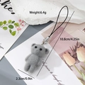 Detail of grey flocked resin bear pendant with silver carabiner and black elastic cord - Gray Koala