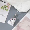 Detail of white flocked kitten charm with soft texture and silver lobster clasp - White Fox