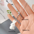 Handheld view of a cute white flocked rabbit charm with silver clasp for bags or phones - Small White Rabbit (10MR39)