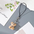 Detailed view of light brown flocked bear keychain with purple polka dot bow and metal clasp - MR70 Brown Bear