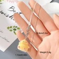 Detail shot showing duck charm size 1.7cm and weight 3.4g with silver lobster clasp - Yellow Flocked Chick Ornament (4MR33)
