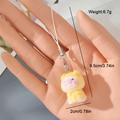 Detail shot of yellow plush pig keychain with dimensions 9.5cm and lobster clasp - Yellow Pig (6MR14)