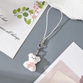 Close-up of a white flocked bear keychain with a pink bow and white braided lanyard - W82 White Bear