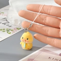 Close-up of yellow flocked duckling keychain with soft velvet texture and metal clasp - Yellow Chick with Blue Tie (9MR87)