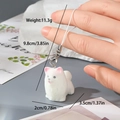 Gros plan d'un porte-clés chiot floqué blanc, dimensions 3,5x2cm et poids de 11,3g - Loulou de Poméranie Blanc (19MR27)