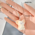 Detail view of mini plush mouse keychain with embroidery held in hand for size context - Mini Mouse (13MR85)