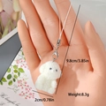 Detail view of white plush puppy keychain with dimensions 9.8cm and silver lobster clasp - Sitting Dog (MR71)