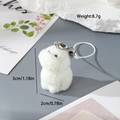 Detail showing 3cm white flocked resin puppy keychain with silver metal clip and braided cord - Looking Up Dog (MR71)
