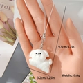 Detailed size view of a white flocked puppy keychain held in hand, measuring 9.5cm in length - Running Dog (MR05)