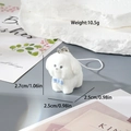 Detail view of a white flocked puppy keychain showing 2.7cm size and blue bow detail - Standing Dog (MR05)