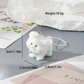 Close-up of white flocked puppy keychain with blue bow and metallic ring pendant - Flying Ear Dog (MR05)