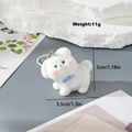 Cute white flocked puppy keychain with blue bow and silver ring on decorative stone - Head Turning Dog (MR05)