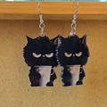Close-up of black acrylic grumpy cat earrings with double-sided print design - Misanthropic Black Cat with Cup Shape (F)