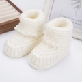 Knitted cream-white newborn booties with cozy ribbed cuffs for warmth and comfort - White