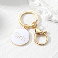 Golden keychain with white enamel round pendant featuring Girls engraved lettering - White Round Style (Girls)