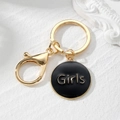 Detail of golden heart-shaped keychain with Girls letter engraving and black enamel finish - Black Round Style (Girls)