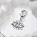 Macro shot of silver evil eye alloy pendant with lobster clasp on stone texture - Silver Eyelash Eye (Lobster Clasp)