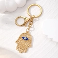 Vintage golden Hamsa Hand keychain with blue Evil Eye charm and secure lobster clasp - Gold Hollow Hamsa