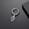 Macro detail of silver stainless steel hoop earring with hollow monstera leaf pendant - Silver Hollow Leaves