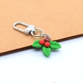 Close-up of a Christmas holly leaf resin keychain with red berries and silver metal clasp - Bear with Green Leaves