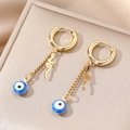 Detail of gold snake charm and blue evil eye bead on stainless steel hoop earrings - Blue Eye Snake Charm / Gold