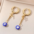 Gold evil eye hoop earrings with star charms and blue beads on a beige jewelry tray - Royal Blue Eye Star Charm / Gold